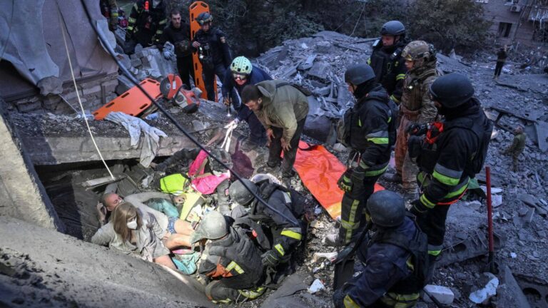 Rescuers search the rubble of a residential building hit by a Russian strike in Ukraine